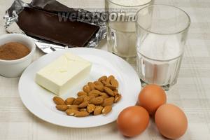 Продукты, необходимые для пирога Зебра: яйца, сахарная пудра, мука, сливочное масло, какао, миндаль и чёрный шоколад.