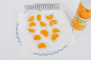 Консервированные мандарины вынем из банки и выложим на салфетку для удаления лишней жидкости.