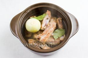 Добавить душистый перец и лавровый лист. Залить мясо горячей водой, чтобы она слегка покрыла рёбра. Поставить на медленный огонь. Тушить в течение 30 минут.