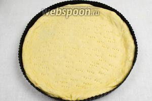 Дно формы смазать оливковым маслом. Растянуть первую часть теста по дну формы. С помощью вилки наколоть тесто лепёшки по дну формы.