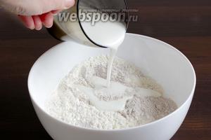 В муку влить кефир или любой молочный продукт — сметану, молоко, ряженку... Можно то и другое пополам.