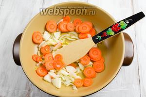 На разогретую сковороду с оливковым маслом выложить лук и морковь. Пассеровать до прозрачности лука, в течение 15 минут.