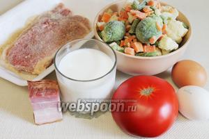 Для приготовления запеканки взять отбивные, овощную заморозку, молоко, яйца, молотые сухари, сыр, помидор, бекон, пряности, соль.