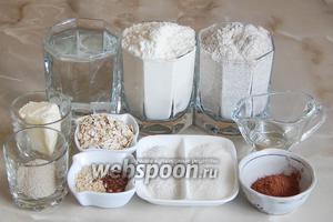 Для приготовления пшенично-ржаных булочек нам понадобятся такие продукты: 2 вида муки (пшеничная и ржаная), овсяные хлопья, какао-порошок, соль, сахар, масло сливочное и подсолнечное, дрожжи сухие (можно заменить свежими — 15 граммов), вода тёплая кипячёная, кунжут белый, семена льна.