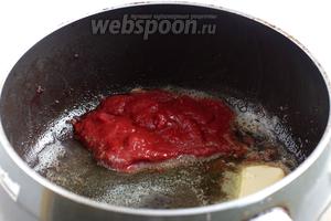 В сотейнике растопить сливочное масло и добавить томатную пасту, всё смешать и прогреть. 