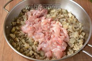 Куриное мясо порезать кубиками. Добавить к обжаренному луку и грибам. Обжариваем курицу около 7 минут.