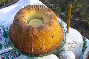 Теперь сделаем ещё вкусней нашу выпечку. Это изделие у нас будет скорей даже не куличом, а кальвадосовой бабой с лимоном. Смешаем помадку из сахарной пудры, лимонного сока и кальвадоса. Зальём в несквозное глубокое отверстие алкогольную помадку с лимонным вкусом, сделаем потёки по всей поверхности «бабы». Сверху украсим углубление широким кружочком лимона. Когда выпечка постоит, помадка подсохнет, а алкоголь впитается, мы получим особенное, более влажное тесто.