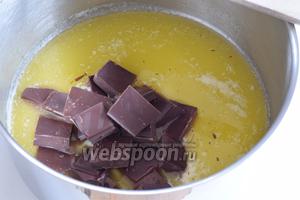 Растопим масло в широкой кастрюле и добавим поломанный на куски шоколад. Убираем с огня, мешаем венчиком до полного растворения шоколада.