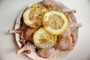 Перекладываем тушки нарезанным чесноком и дольками лимона. Чеснок беру молоденький, он не такой ядрёный. Оставляем мариноваться.