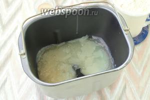 В контейнер хлебопечки влить молочную сыворотку и добавить растопленный смалец. Сыворотку также можно подогреть, тогда смалец не возьмётся кусочками, хотя при замесе это не играет никакой роли.