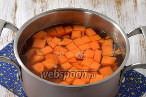 Опустить подготовленную тыкву в кипящую воду с сахаром и проварить под крышкой на слабом огне 12-15 минут.