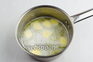В воду (200 мл) выложить кусочки сливочного масла (100 г) и соль (1 щепотку). Довести до кипения на среднем огне.