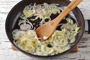 Тем временем очистить репчатый лук (1,5 штуки), нарезать его полукольцами и обжарить на сливочном масле (2 ст. л.) до прозрачности.